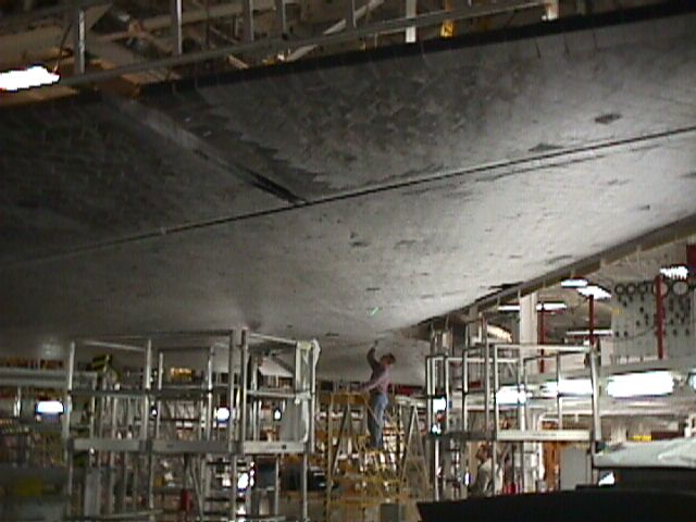 Technician working on 'Discovery' after its mission which returned our first experiments