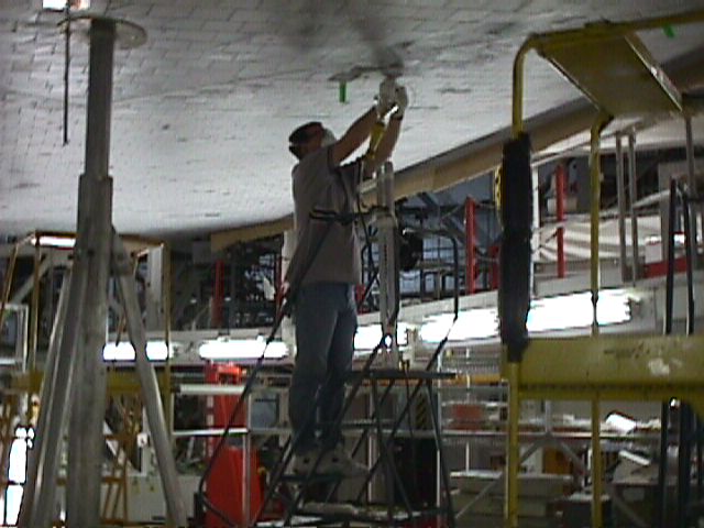 Tile repair after Discovery's John Glenn mission