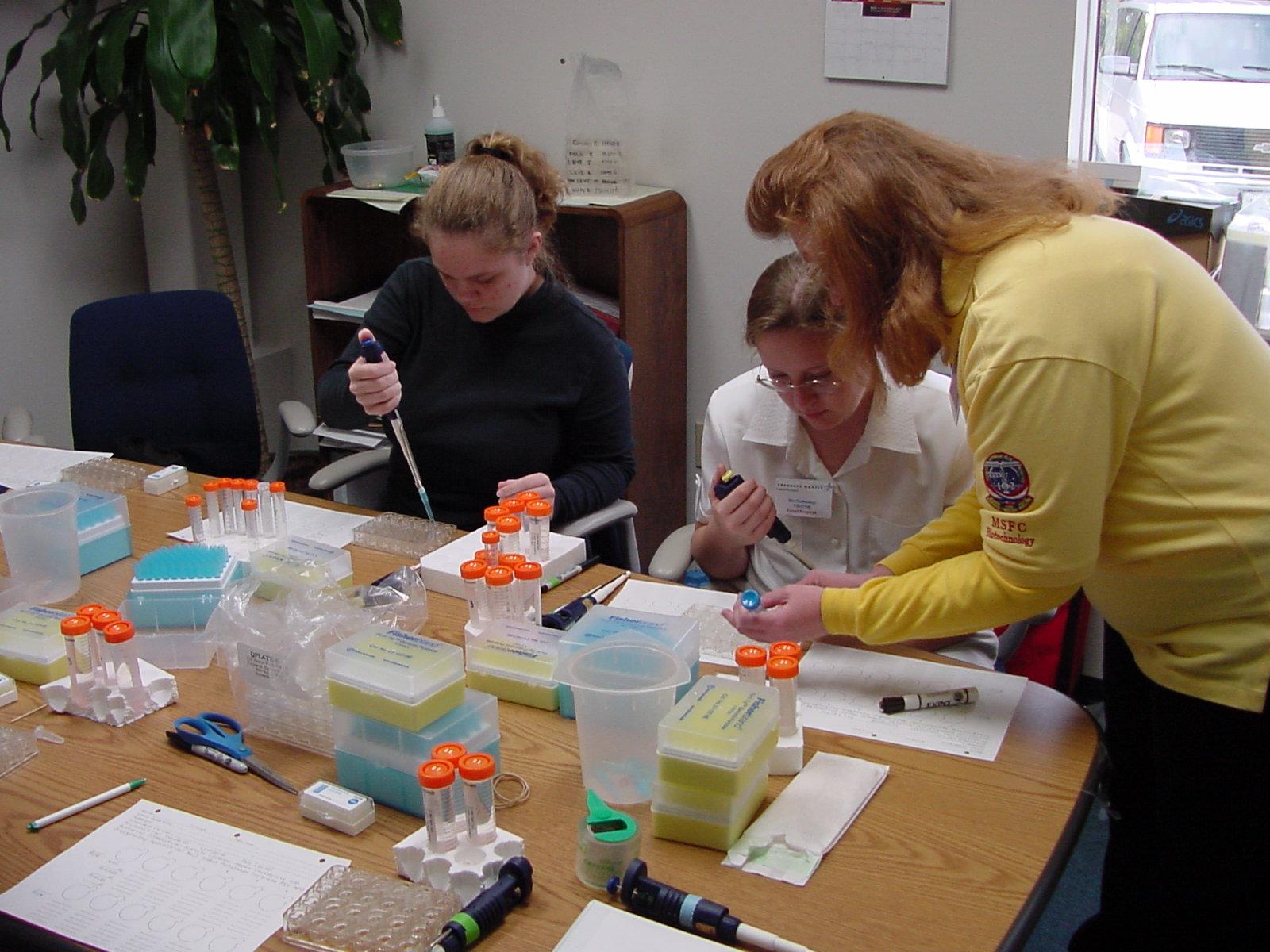 Amanda Hamilton from Terry Parker and Noel Jones from Peterson Academy work with Anna