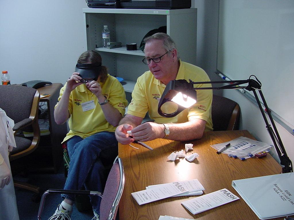 Wendell Elrod and a teacher discuss quality control checks
