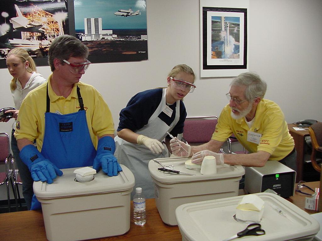 Merle Myers helps a student while Dave Hall looks on