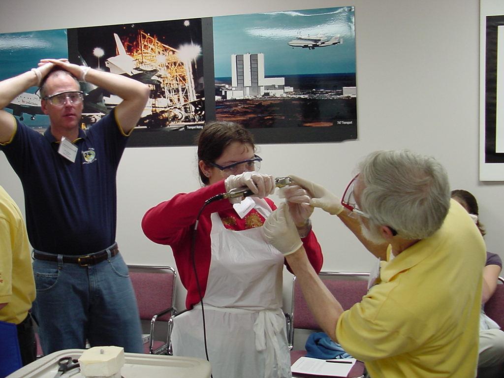 Merle Myers helps student with a heat seal