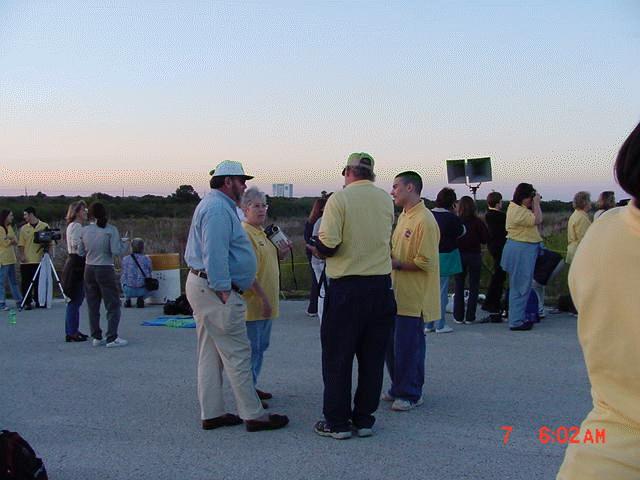Mr. Smit (back to camera) talks with Terri Granger, at teacher from Land O' Lakes HS in Pasco County, and Nate Kenny and his father