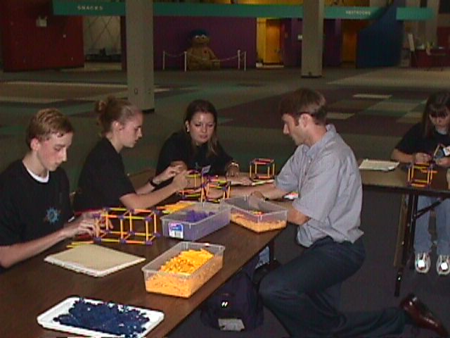 Brannon Carter helps Elise Humbert with her model.