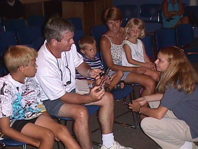 Kim shows protein crystals to a family at MOSH