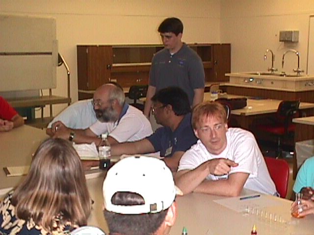 Steven Nepowada observes the teachers' lab activity progress