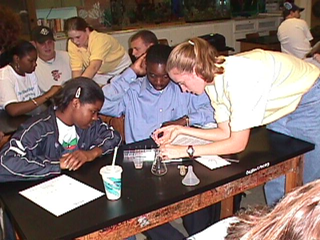 Elise H. and Katie Cauthen (yellow shirts) assist UNF student